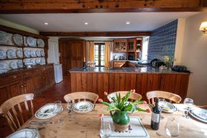 a kitchen with a table with chairs and a counter at Glasfryn Fawr in Pwllheli
