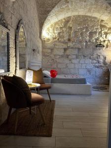 a bedroom with a bed and a table and chairs at Amarcord private Spa Ostuni in Ostuni