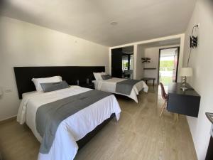 Voodi või voodid majutusasutuse Malokas Resort - Socorro - San Gil toas