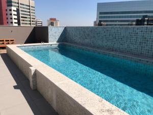 a swimming pool on the roof of a building at Studio Luxo Expo SP Itaú in Sao Paulo