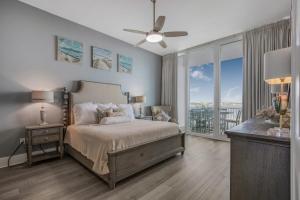 a bedroom with a bed and a large window at Caribe Resort D106 by Vacation Homes Collection in Orange Beach