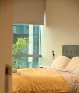 a bedroom with a bed with a large window at O2 Arena 2Bedroom Flat, London 05 in London