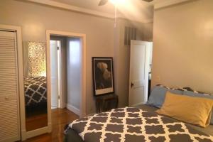 a bedroom with a bed and a door to a room at Urban Retreat on Flint in Jonesboro