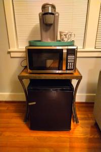 a microwave sitting on top of a table with a blender at Urban Retreat on Flint in Jonesboro