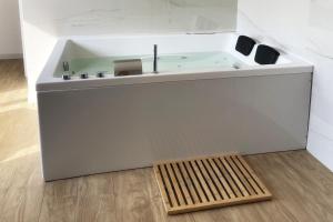 een badkamer met een wastafel en een houten vloer bij Luxury - 5 Stars - Suite 70's rooms in Trapani