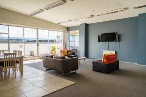 a living room with a couch and a table at Ibis Styles Invercargill in Invercargill