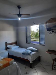 a bedroom with two beds and a window at Hotel Calcinfer in São João del Rei +96 photos