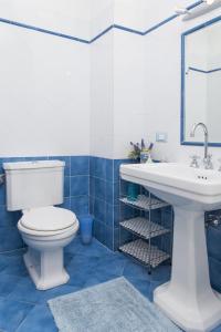 a bathroom with a white toilet and a sink at Il Giardino di Laura in Corsanico-Bargecchia