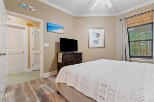 a bedroom with a bed and a flat screen tv at Phoenix On The Bay 1108 by Vacation Homes Collection in Orange Beach