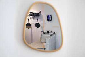 a mirror reflecting a kitchen with pots and pans at Exquisite 1st Floor Apartment in Sheffield +21 photos