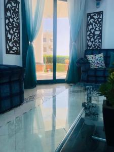 a living room with a couch and a large window at Paradise Gates Golden Beach two in Ras Sedr