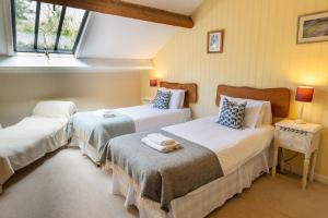 Postel nebo postele na pokoji v ubytování The Coach House