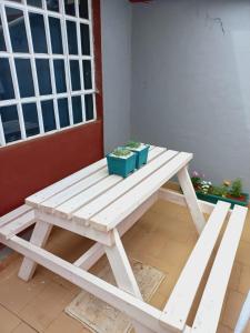 a picnic table with two potted plants on it at Fully Furnished 2BR Eclectic Homestay near UOE in Eldoret