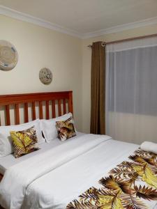 a bedroom with two beds and a window at Fully Furnished 2BR Eclectic Homestay near UOE in Eldoret