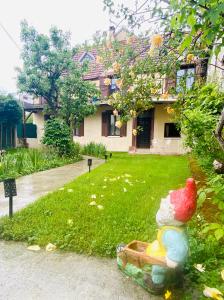 a statue of a chicken sitting in front of a house at Appartement indépendant avec jardin in Saint-Clément