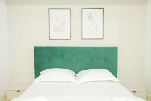 a bedroom with a bed with three pictures on the wall at Himson Stylish Studio-Self Check-in near Airport & Mall in Iaşi