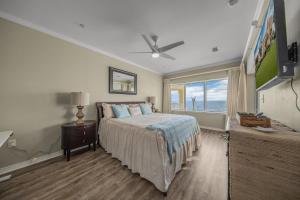 a bedroom with a bed and a large window at Marlin Key 4C by Vacation Homes Collection in Orange Beach