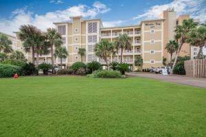a large lawn in front of a building at Marlin Key 4C by Vacation Homes Collection in Orange Beach