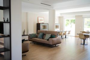 a living room with a couch and a table at Villa Erada in Bari