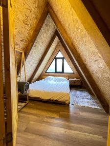 a bed in a room with a window at Riverside house in Akcaabat