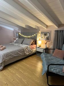 a bedroom with a large bed and a couch at Spitaki in Alepou