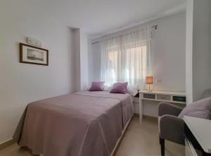 Habitación blanca con cama y ventana en Apartamento Miró, en Calpe