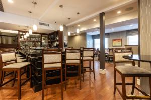 a restaurant with tables and chairs and a bar at The Centennial Hotel in Concord
