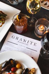 a table with a plate of food and a wine glass at The Centennial Hotel in Concord