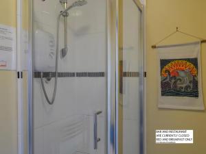 a shower with a glass door in a bathroom at Hope & Anchor, Hadrian's Wall, Port Carlisle, Solway Firth, Area of Natural Beauty in Port Carlisle