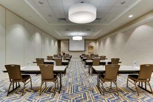 a conference room with tables and chairs and a whiteboard at Drury Plaza Hotel Cincinnati Florence in Florence