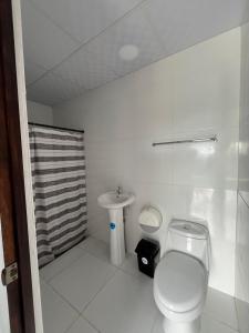 a bathroom with a toilet and a sink at Casa monte sion in Nueva San Salvador