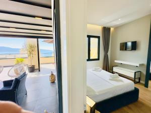 a bedroom with a bed and a view of the ocean at SEA VIEW LUXURY PENTHOUSE in Vlorë