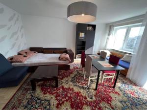 a living room with a bed and a table at Warsaw Lux Rooms in Warsaw