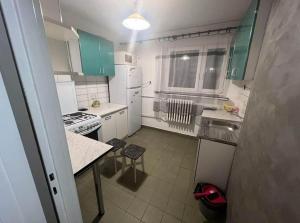a small kitchen with white appliances and green cabinets at Warsaw Lux Rooms in Warsaw