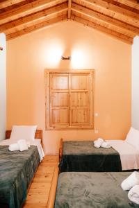 a room with two beds and a window at The Traditional House of Molivos in Mythimna