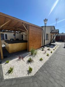 a backyard with a wooden building with a pavilion at Na Spokojnie in Jastarnia