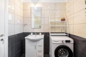a bathroom with a washing machine and a sink at Kassiani-Sofia Cottage 1,5 km from beach in Gouvia