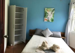 a room with a bed with a stuffed animal on it at Bolimar at Playa Hermosa, Guanacaste in Playa Hermosa