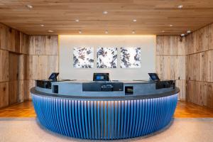 a lobby with a circular counter with two computers on it at Nagoya Kasadera Hotel in Nagoya