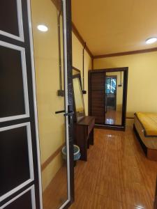 a door to a room with a bed and a desk at Permata Beach Chalet in Kampong Juara