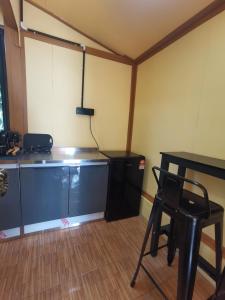 a room with a desk and a table and a chair at Permata Beach Chalet in Kampong Juara