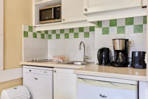 a kitchen with a sink and a counter top at Citea Deauville - Tourisme & Vacances mer in Deauville