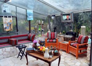a living room with two couches and a table at بيت الطبيعة nature house in Jerash