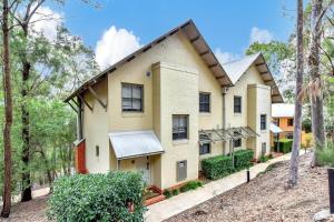 a house in the woods with trees at Villa 3br Chianti Villa located within Cypress Lakes Resort in Pokolbin