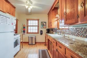 a kitchen with wooden cabinets and white appliances at Pet-Friendly St Paul Home Less Than 5 Mi to Downtown! in Lilydale