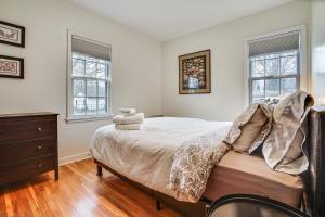 a bedroom with a bed and two windows at Pet-Friendly St Paul Home Less Than 5 Mi to Downtown! in Lilydale