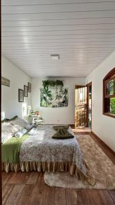 a bedroom with a large bed in a room at Hostel 040 in Itaipava