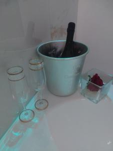 a bucket with a bottle of wine and two glasses at Borgo La Chiusa in Cinisi
