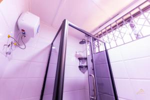 a shower in a bathroom with a glass door at HomeAwayFromHome Villa in Lapaz +60 photos