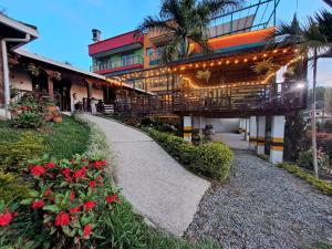 a building with a walkway in front of it at Guatapé Country House Hotel in Guatapé